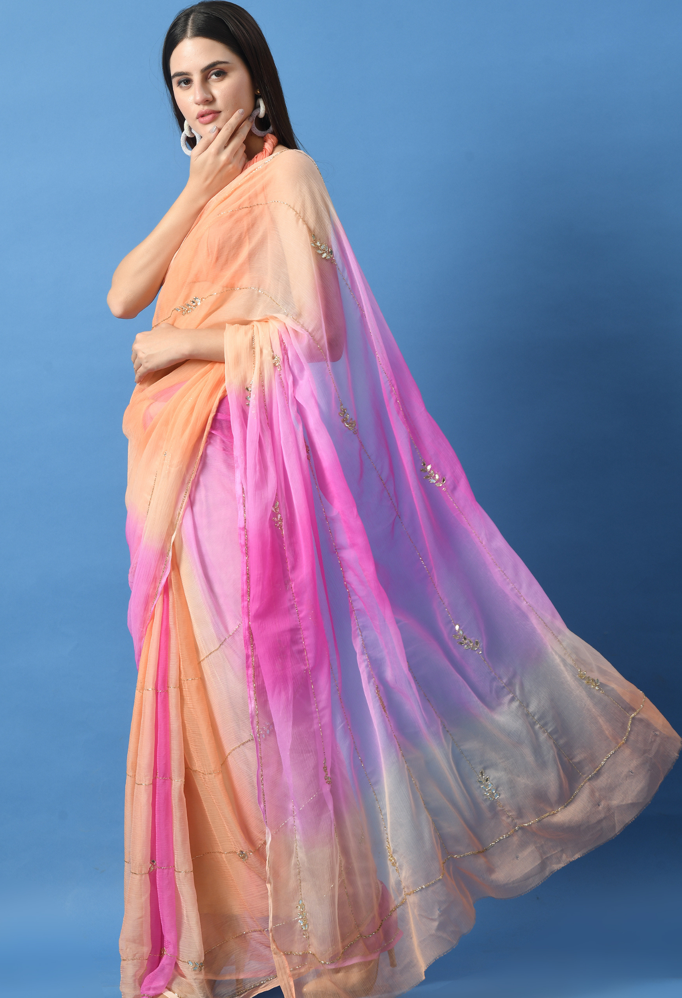 Peachy Pink Embellished chiffon saree styled as festive wear, daily wear saree, and party wear saree, a versatile trousseau saree for weddings.