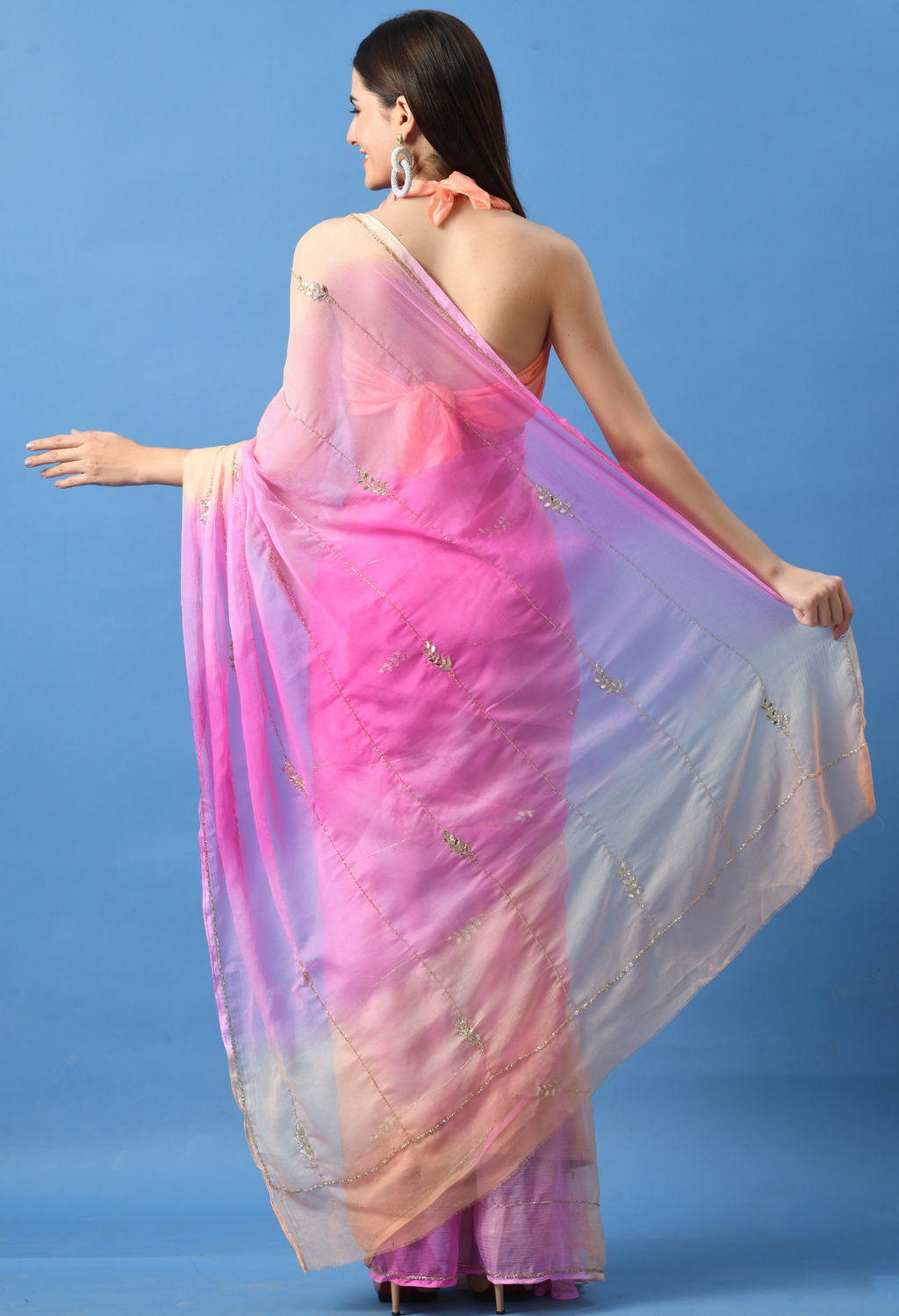 Peachy Pink Embellished chiffon saree styled as festive wear, daily wear saree, and party wear saree, a versatile trousseau saree for weddings.