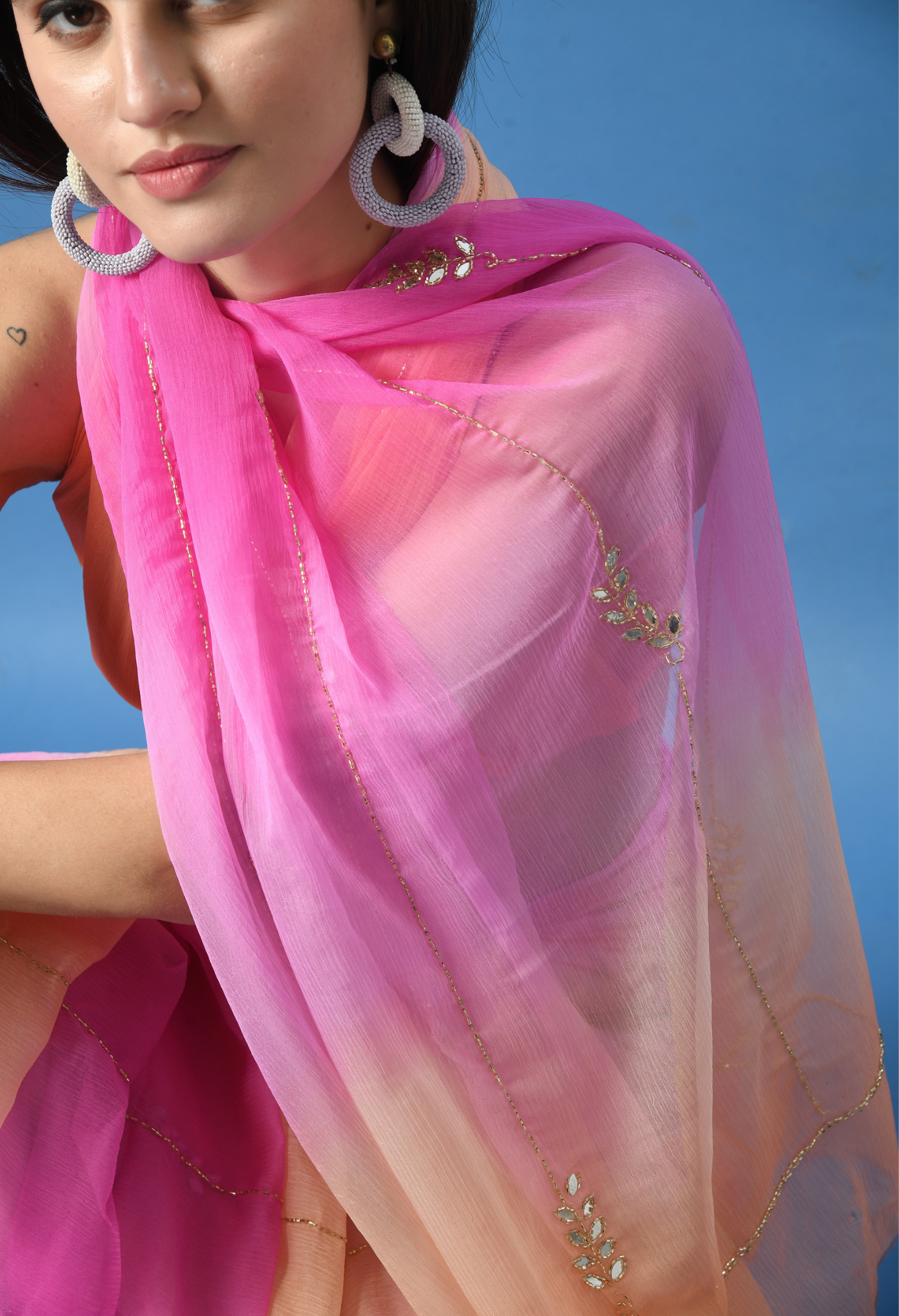 Peachy Pink Embellished chiffon saree styled as festive wear, daily wear saree, and party wear saree, a versatile trousseau saree for weddings.