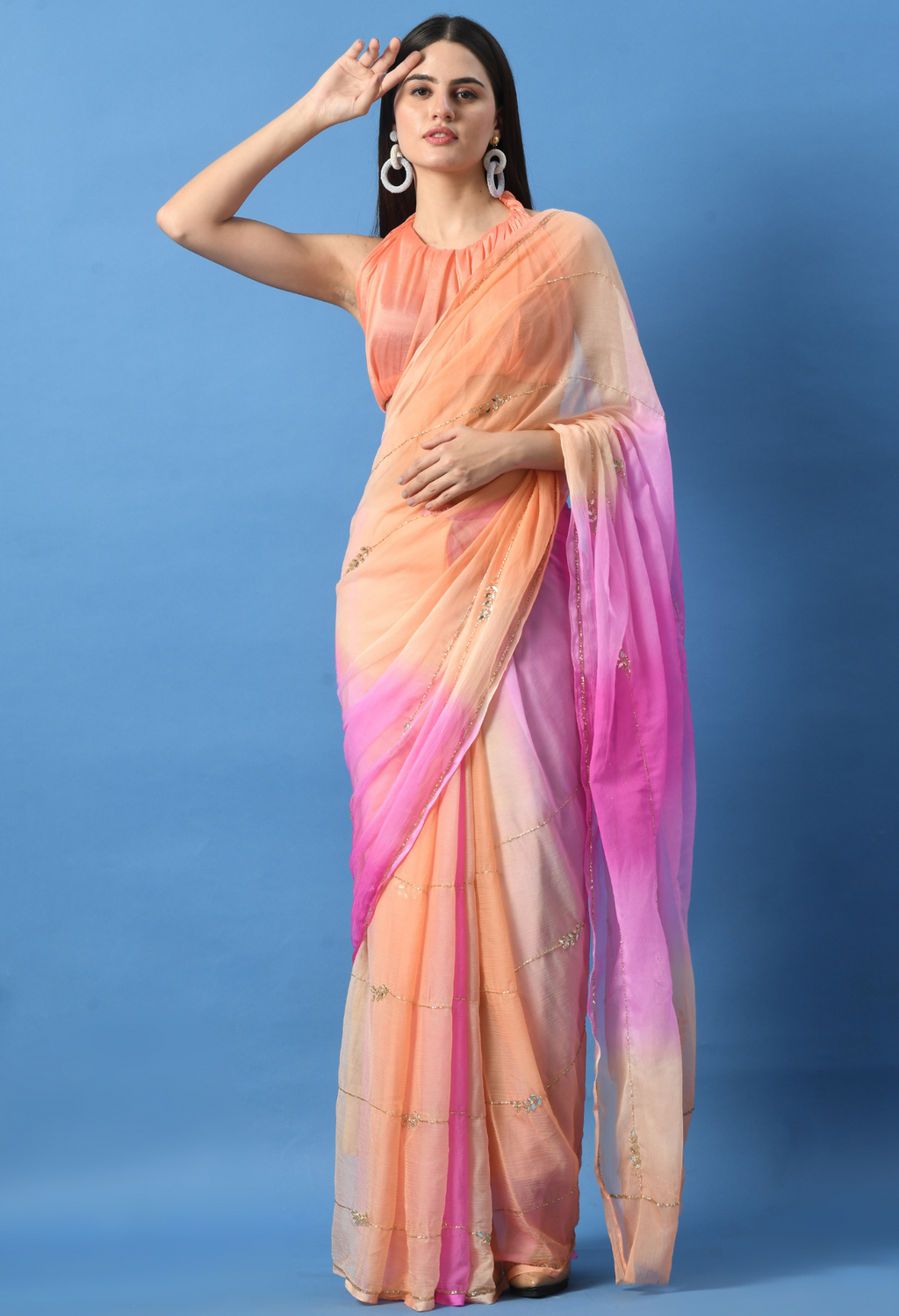 Peachy Pink Embellished chiffon saree styled as festive wear, daily wear saree, and party wear saree, a versatile trousseau saree for weddings.
